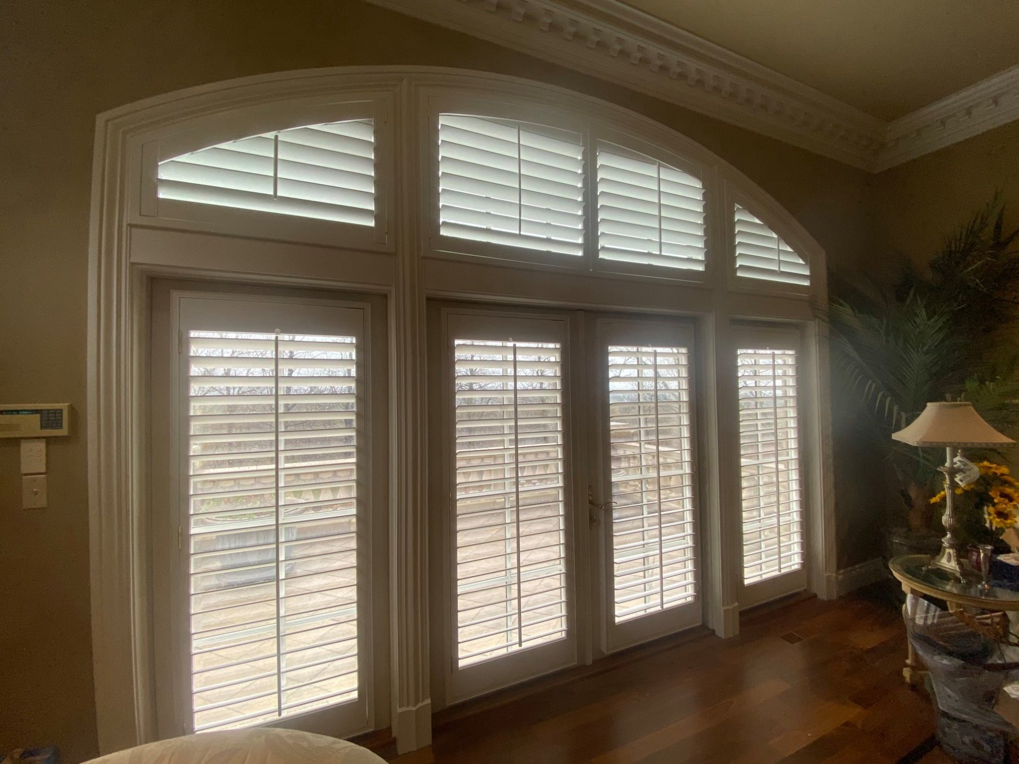 Carolina Blinds installation — custom arch shutters on French doors with transom